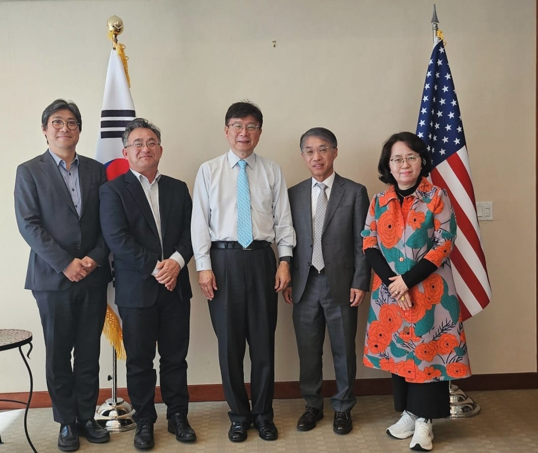 Five KAMDA leaders standing between the Korean and U.S. flags at the Consulate General of Korea in New York.